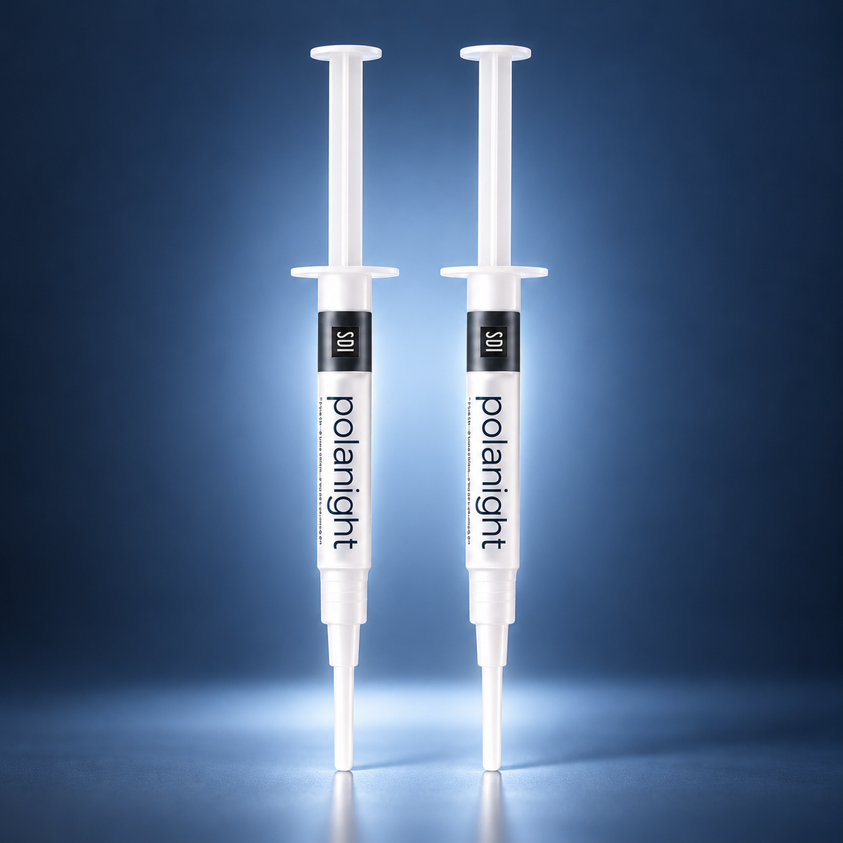 2 SDI PolaNight teeth whitening gel syringes with a soft blue studio glow